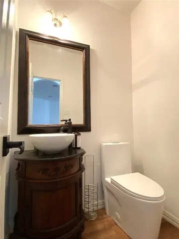 a bathroom with a toilet sink and mirror