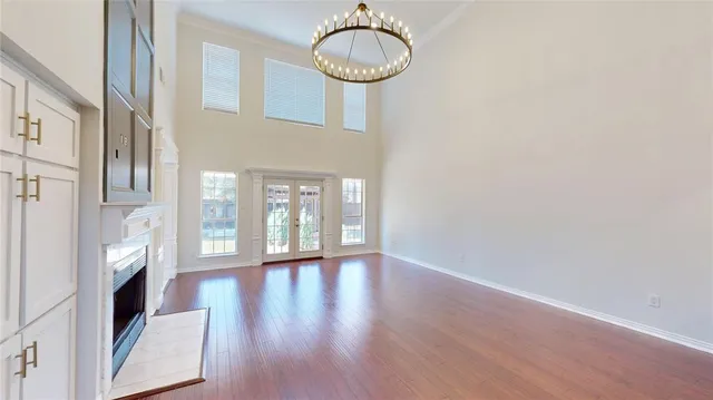 a very nice looking room with wooden floor and entryway