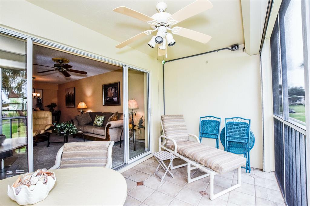 433 Cerromar Lane, Unit 438 Venice, FL 34293 - Photo 24 of 44 a living room with furniture and a chandelier