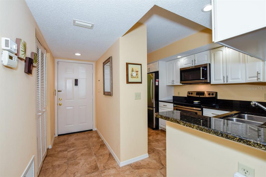 433 Cerromar Lane, Unit 438 Venice, FL 34293 - Photo 3 of 44 a kitchen with stainless steel appliances granite countertop a refrigerator and a stove top oven