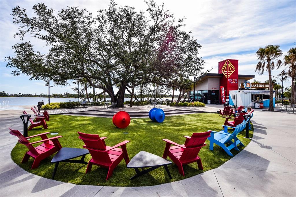 433 Cerromar Lane, Unit 438 Venice, FL 34293 - Photo 41 of 44 a view of yard with swimming pool and outdoor seating