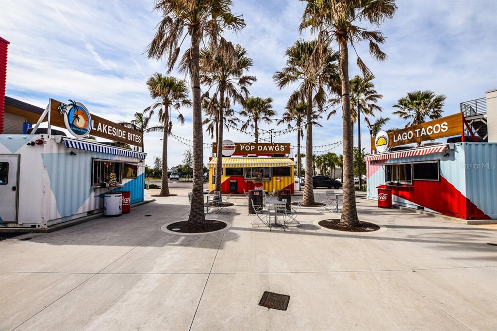 433 Cerromar Lane, Unit 438 Venice, FL 34293 - Photo 42 of 44 a view of road with card and parked cars