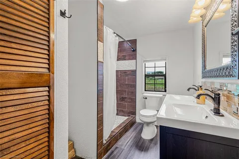 a bathroom with a sink toilet and shower