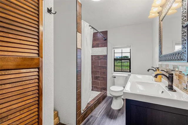 a bathroom with a sink toilet and shower