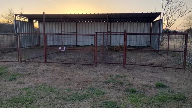 a view of a backyard with wooden fence