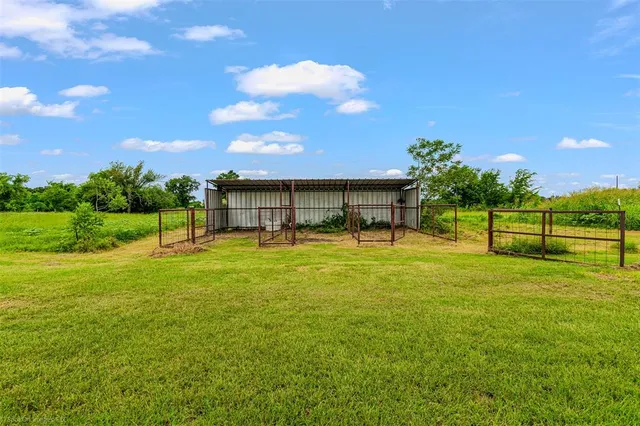 a front view of house with yard and trees