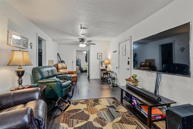 a living room with furniture and wooden floor
