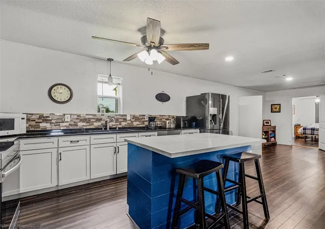 a kitchen with a table and chairs in it