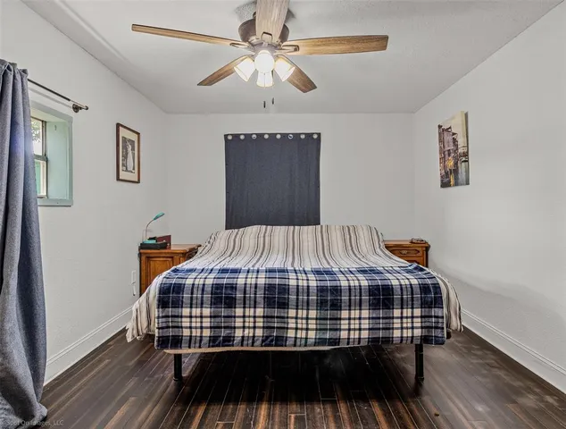 a bedroom with a bed and a ceiling fan
