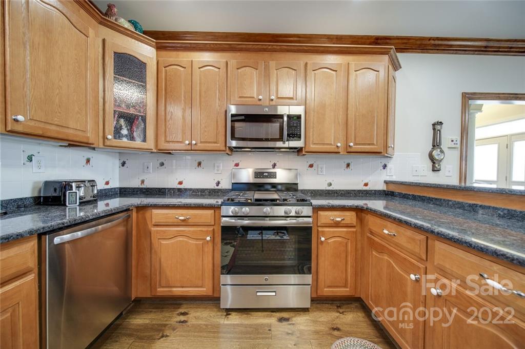 155 St Peters Church Road Gold Hill, NC 28071 - Photo 17 of 47 a kitchen with stainless steel appliances granite countertop a stove a sink and a microwave