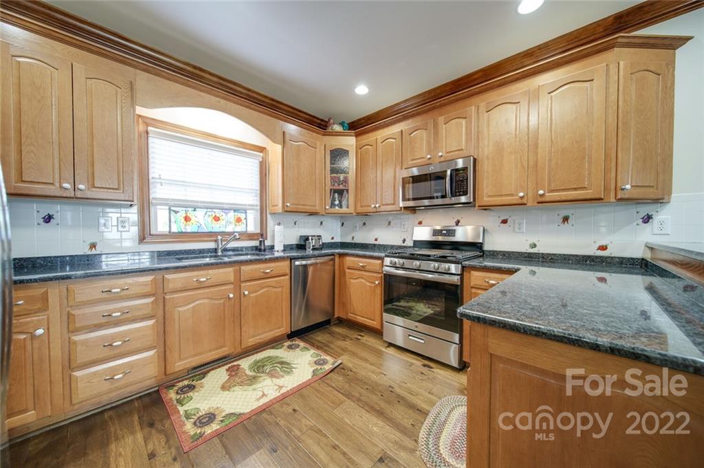 155 St Peters Church Road Gold Hill, NC 28071 - Photo 19 of 47 a kitchen with stainless steel appliances granite countertop a stove a sink and a microwave