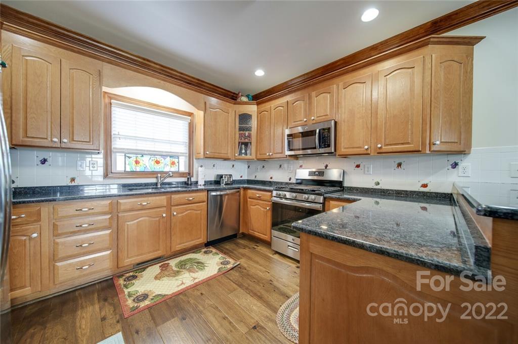 155 St Peters Church Road Gold Hill, NC 28071 - Photo 20 of 47 a kitchen with stainless steel appliances granite countertop a stove a sink and a microwave