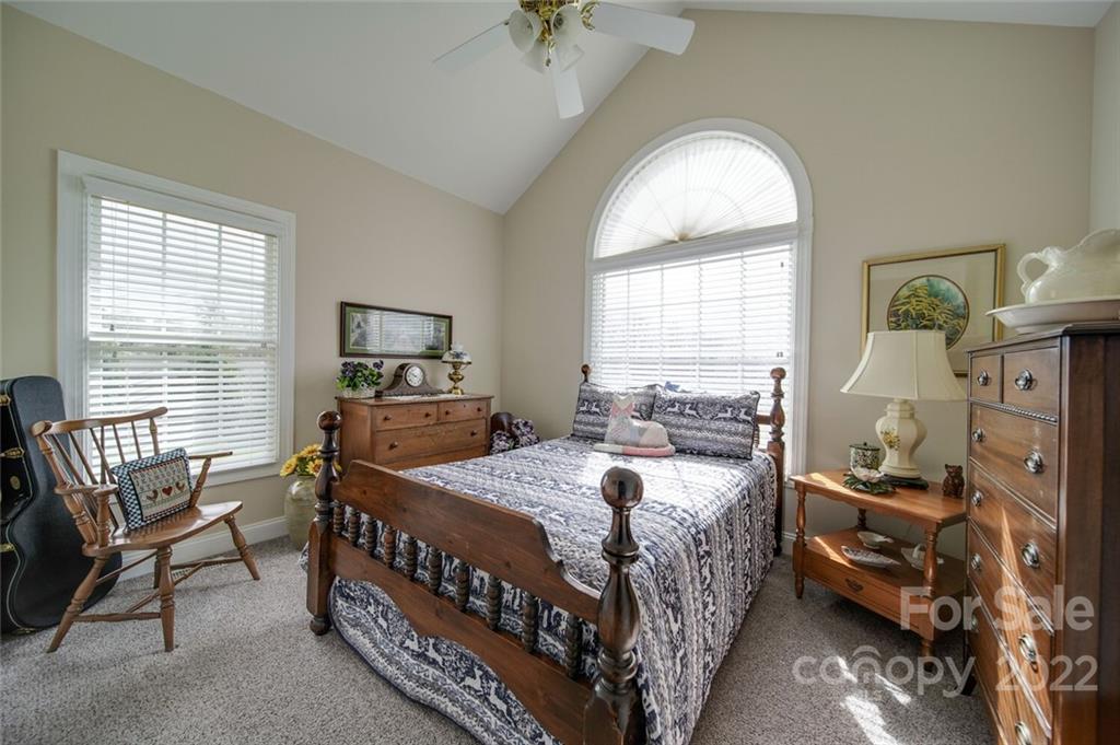 155 St Peters Church Road Gold Hill, NC 28071 - Photo 38 of 47 a bedroom with a bed and a chandelier