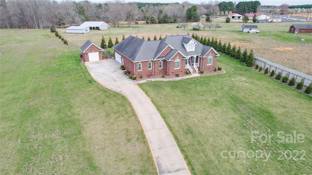 155 St Peters Church Road Gold Hill, NC 28071 - Photo 5 of 47 a view of a swimming pool with a garden and outdoor seating