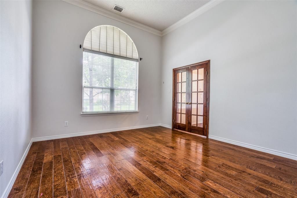 3421 Neiman Road Plano, TX 75025 - Photo 4 of 40 Unfurnished room with french doors, crown molding, and hardwood / wood-style floors