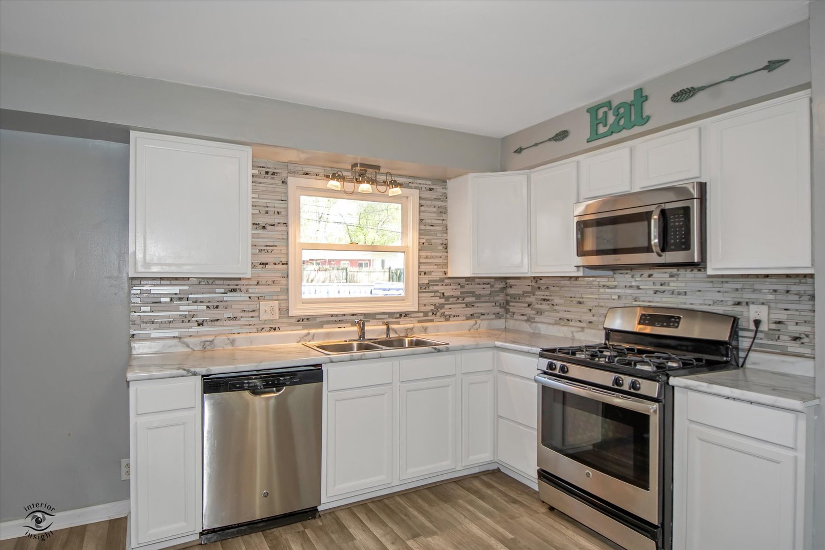 128 North Pinecrest Road Bolingbrook, IL 60440 - Photo 8 of 25 a kitchen with stainless steel appliances a stove sink microwave and cabinets