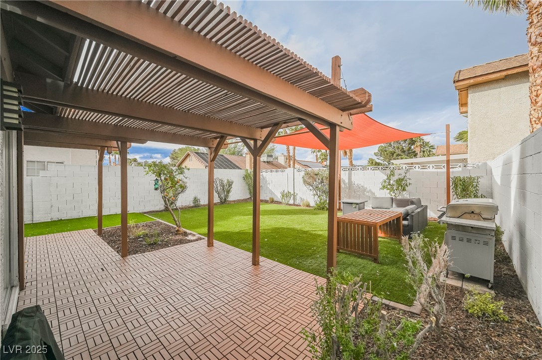 1640 Crystal Shadows Circle Las Vegas, NV 89119 - Photo 39 of 44 Fenced backyard with a patio area, a pergola, and a grill