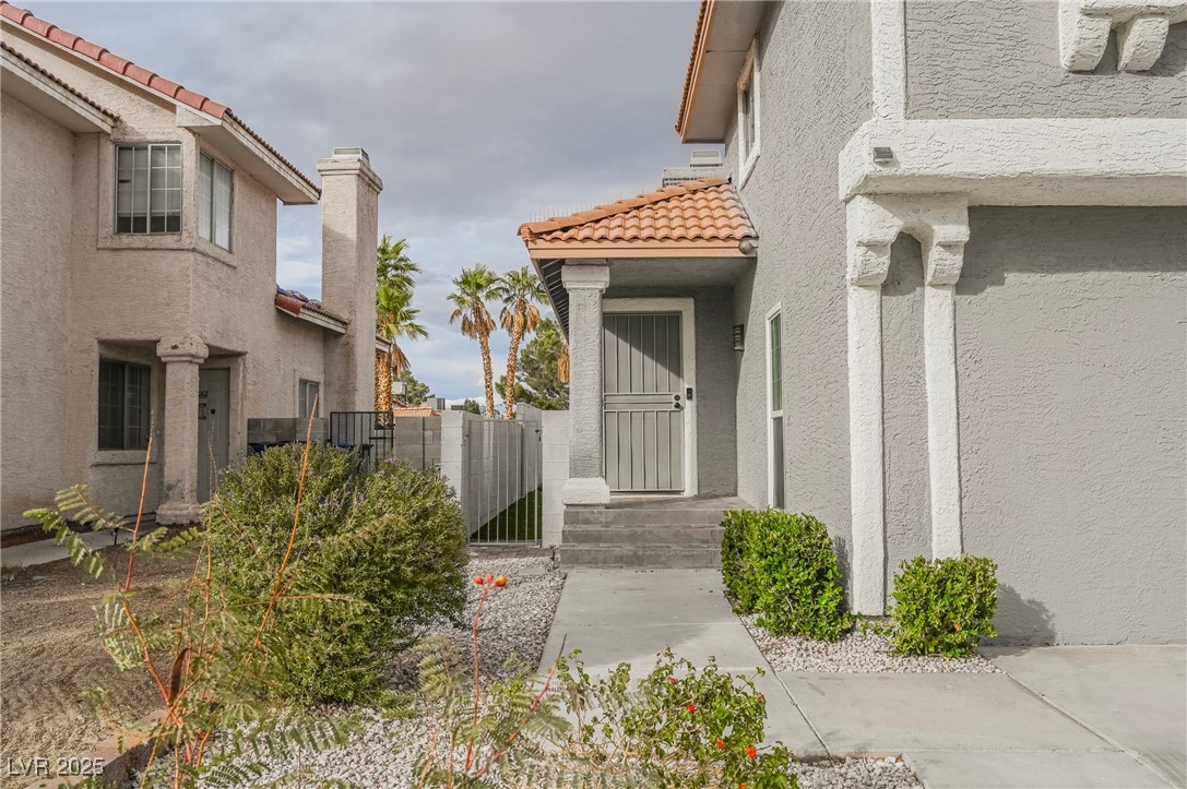 1640 Crystal Shadows Circle Las Vegas, NV 89119 - Photo 43 of 44 View of exterior entry featuring stucco siding and a tile roof