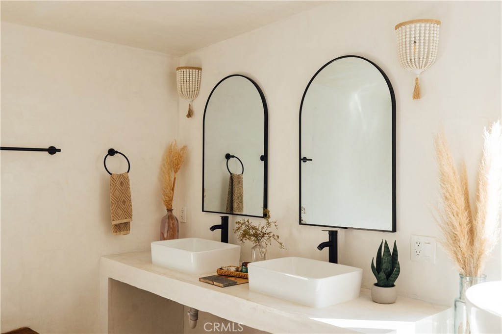 75243 Sullivan Road Twentynine Palms, CA 92277 - Photo 32 of 62 a bathroom with a double vanity sink and a mirror