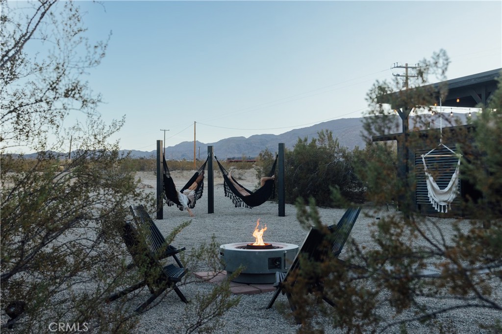 75243 Sullivan Road Twentynine Palms, CA 92277 - Photo 57 of 62 a backyard of a house with table and chairs