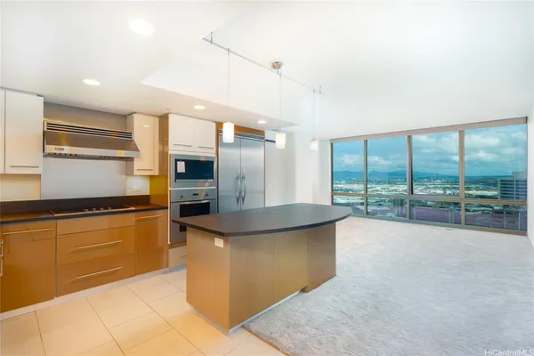 a kitchen with stainless steel appliances granite countertop a sink and a refrigerator