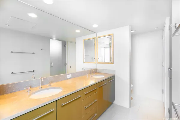 a bathroom with a granite countertop sink and a mirror
