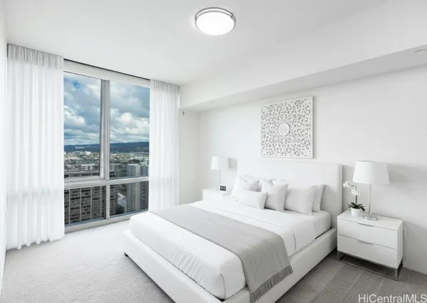 a bedroom with a large bed and a large window