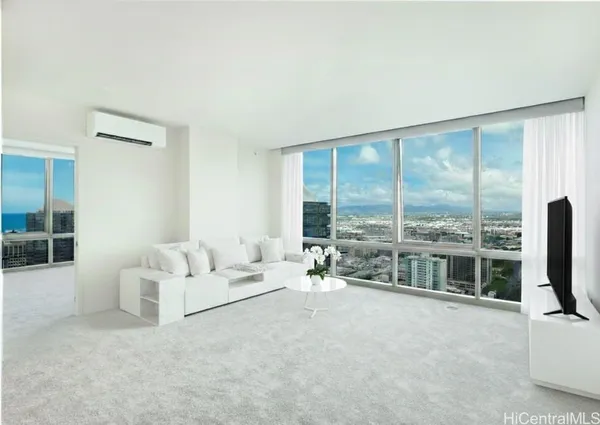 a living room with furniture and large windows