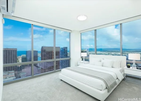 a bedroom with a large bed and a balcony view
