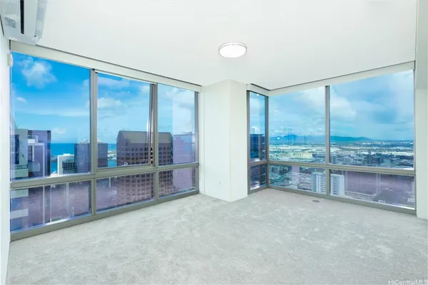 an empty room with furniture and a large window