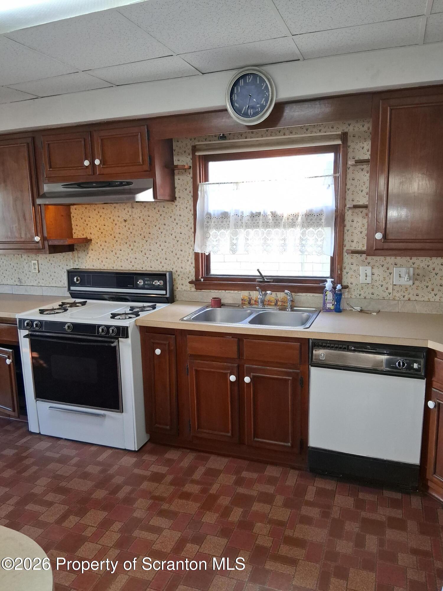72 Welles Street Forty Fort, PA 18704 - Photo 22 of 37 a kitchen with stainless steel appliances granite countertop a stove a sink and a microwave