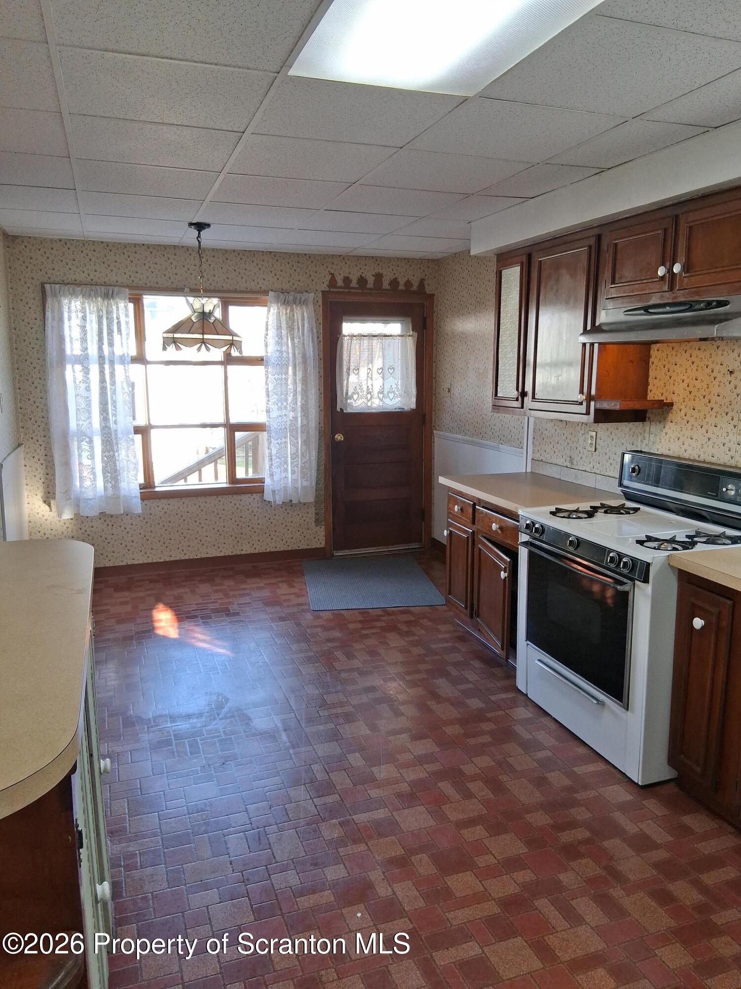 72 Welles Street Forty Fort, PA 18704 - Photo 23 of 37 a kitchen with stainless steel appliances granite countertop a stove a sink and a refrigerator