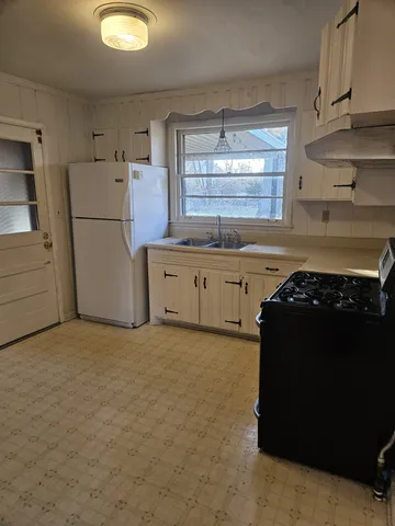 a view of a livingroom with an empty space and a window