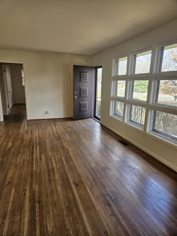a kitchen with granite countertop white cabinets and stainless steel appliances