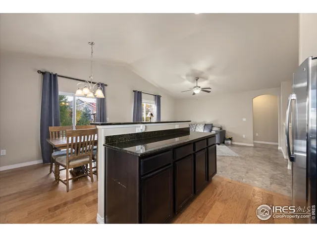 a kitchen with stainless steel appliances and granite countertop wooden cabinets