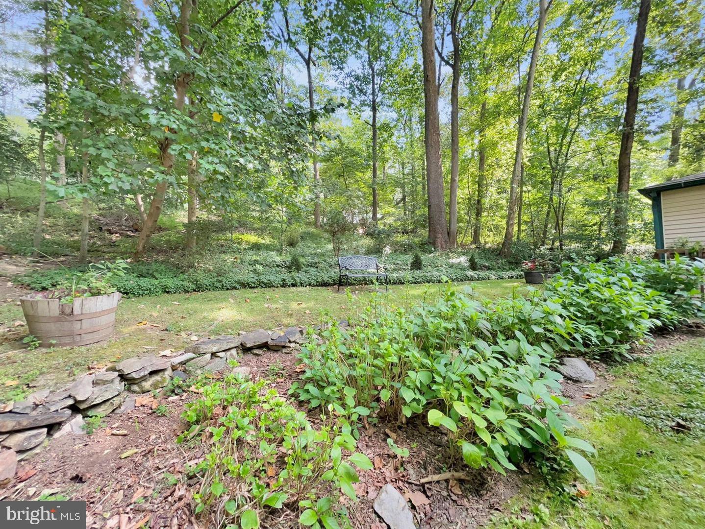 402 Norwood Road Downingtown, PA 19335 - Photo 20 of 21 a view of a garden with a bench