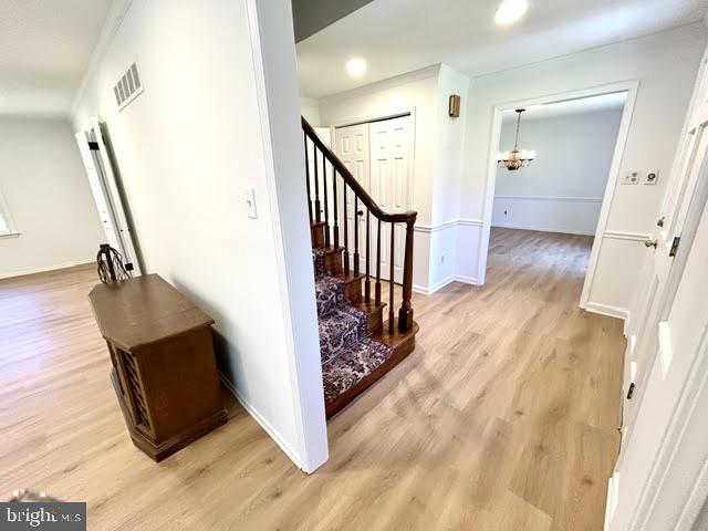 402 Norwood Road Downingtown, PA 19335 - Photo 4 of 21 a view of a hallway with wooden floor and staircase