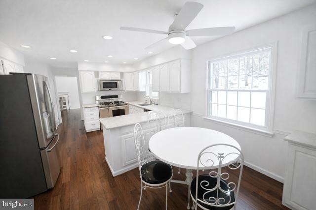 402 Norwood Road Downingtown, PA 19335 - Photo 7 of 22 a kitchen with stainless steel appliances a table chairs and a window