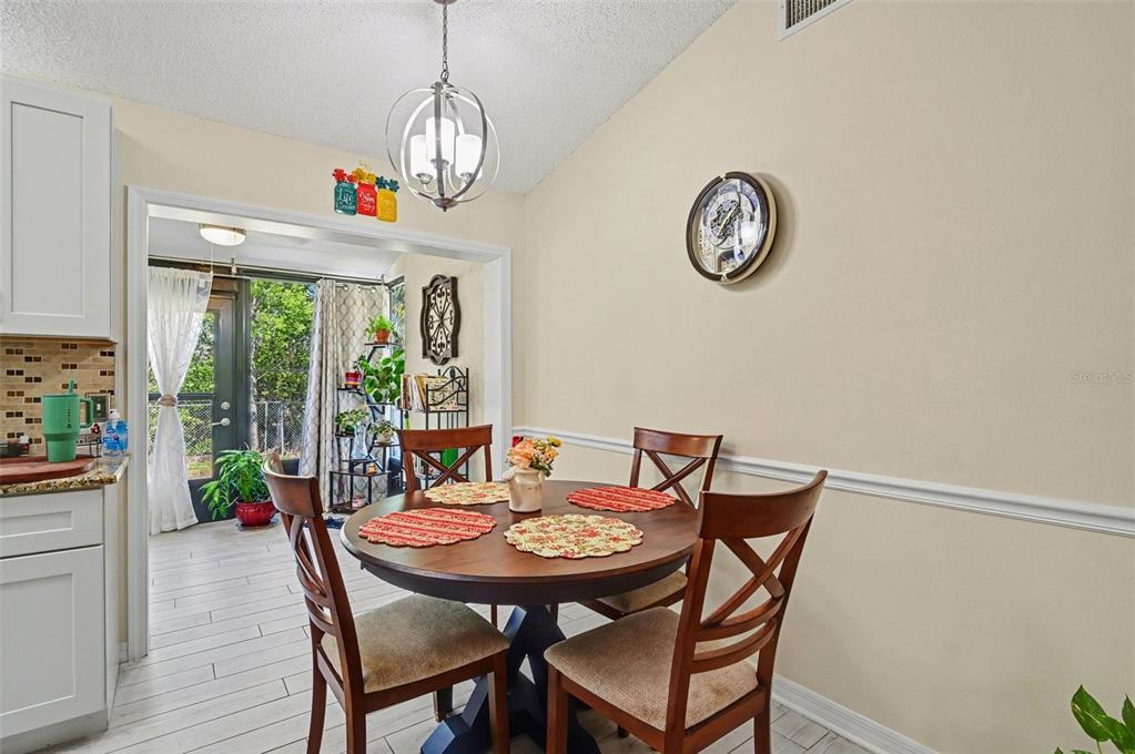 12435 Orangewood Circle Tavares, FL 32778 - Photo 10 of 30 a view of a dining room with furniture window and outside view
