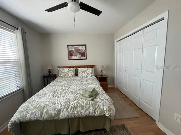 a bed sitting in a bedroom next to a window
