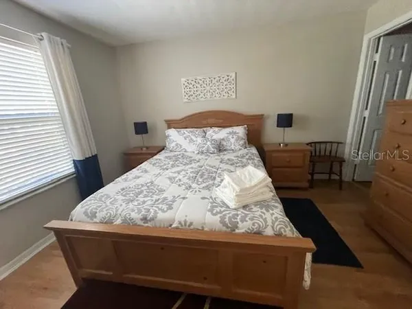 a bed sitting in a bedroom next to a window