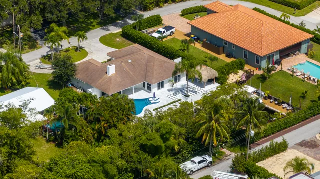 an aerial view of a house with yard swimming pool and outdoor seating