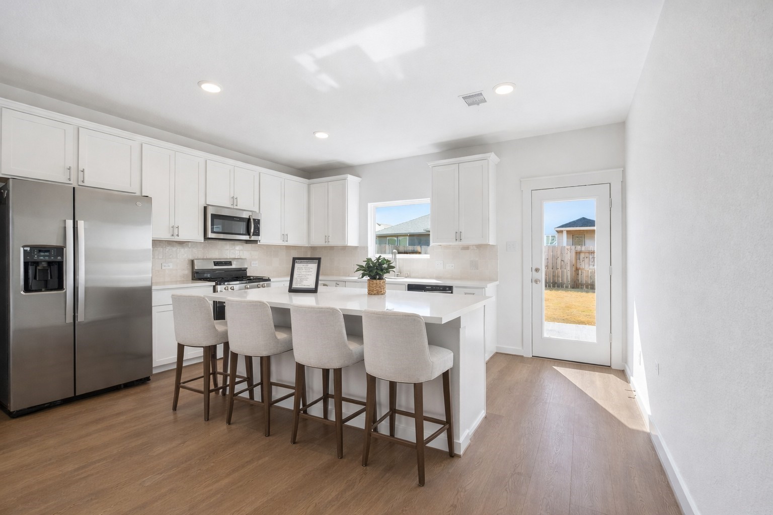 4418 Azalea Blossom Road Pinehurst, TX 77362 - Photo 3 of 31 virtually staged kitchen with island big enough for 4 barstools