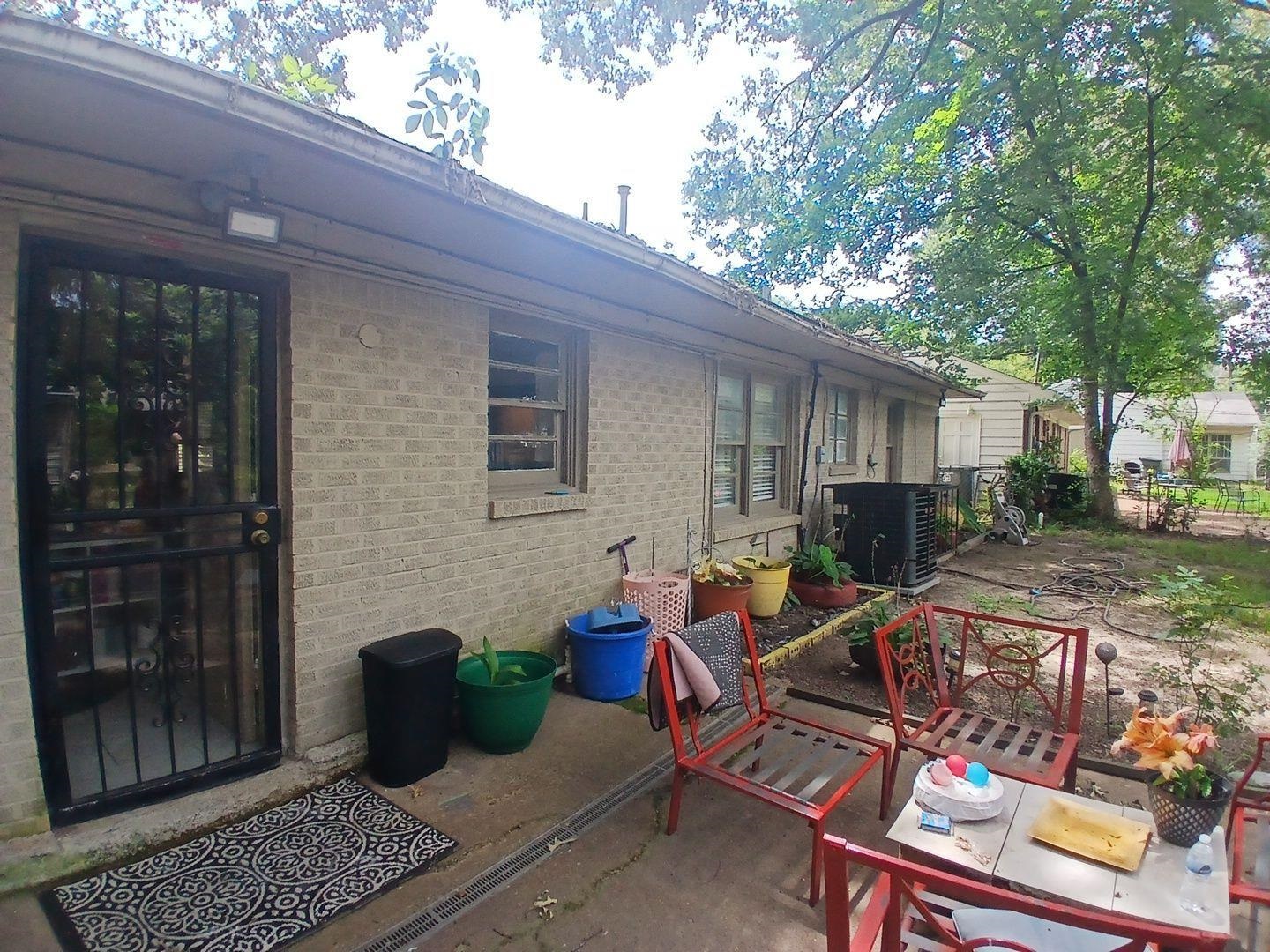 4480 Garnett Road Memphis, TN 38117 - Photo 8 of 15 Brick exterior with multiple windows and a security screen door