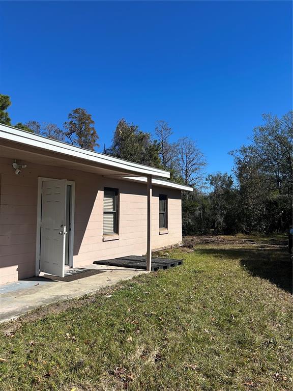 5927 Lynn Road Tampa, FL 33624 - Photo 6 of 9 a view of a house with backyard and garden