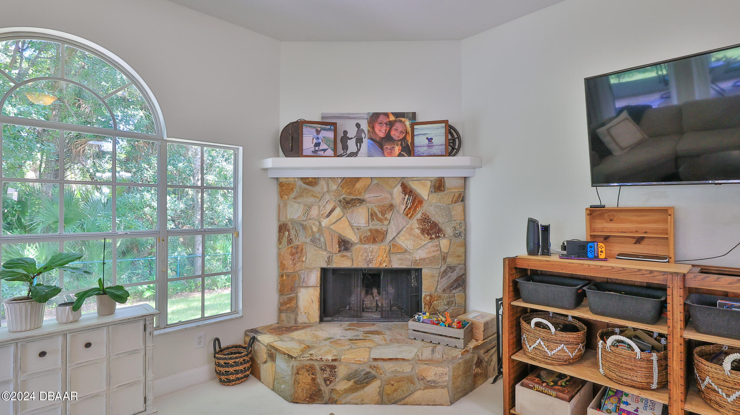 16 Meadow Ridge View Ormond Beach, FL 32174 - Photo 17 of 45 a living room with a fireplace and a flat screen tv