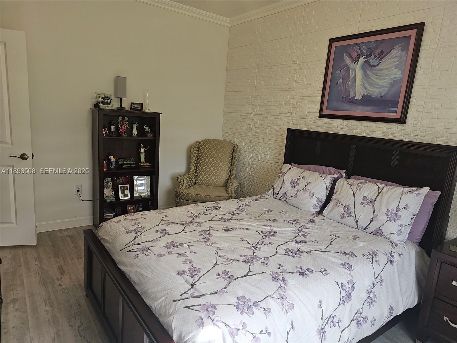 18964 Southwest 135th Avenue Miami, FL 33177 - Photo 11 of 39 a bedroom with a bed and wooden floor