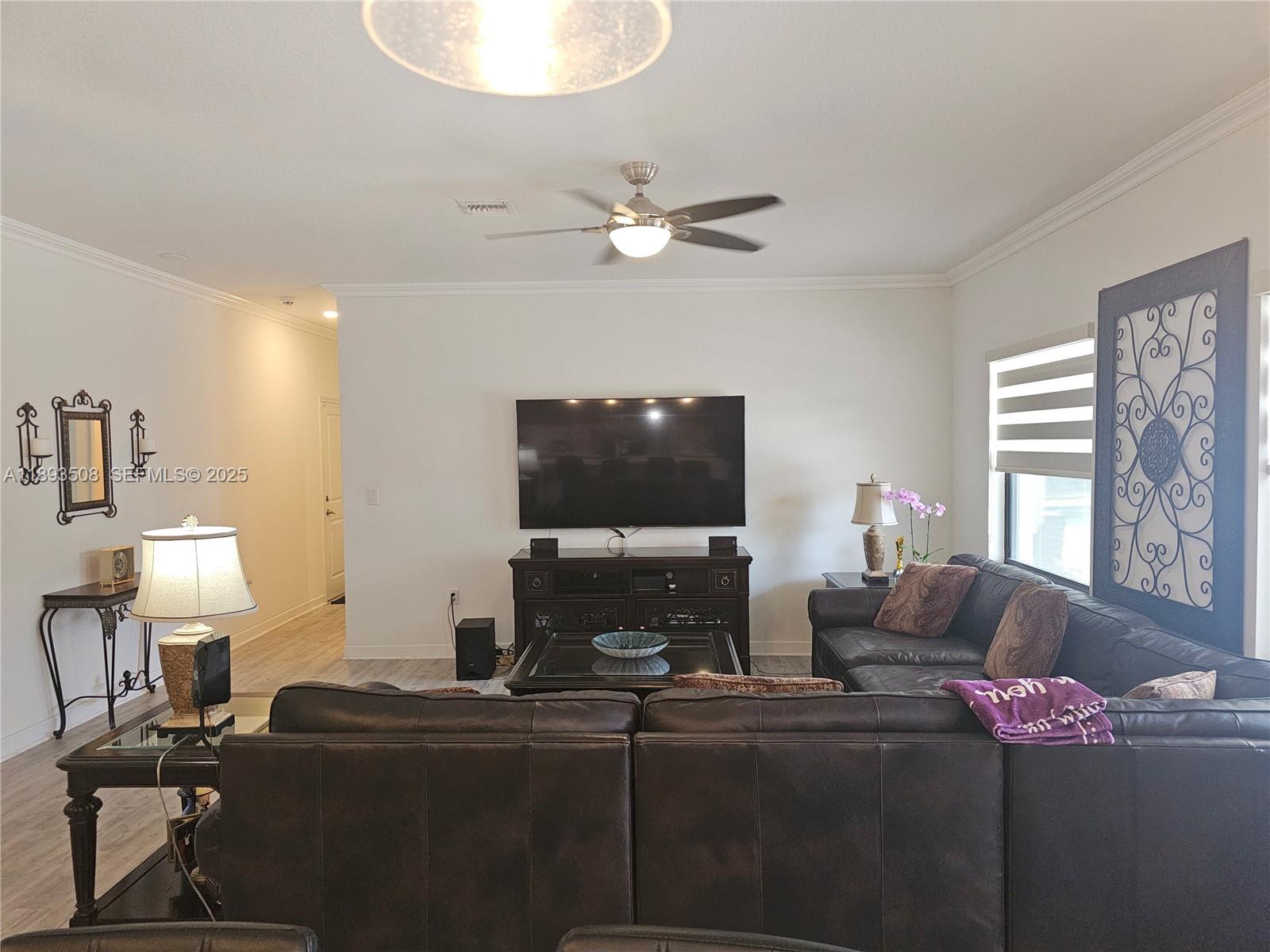 18964 Southwest 135th Avenue Miami, FL 33177 - Photo 17 of 39 a living room with furniture a flat screen tv and a window