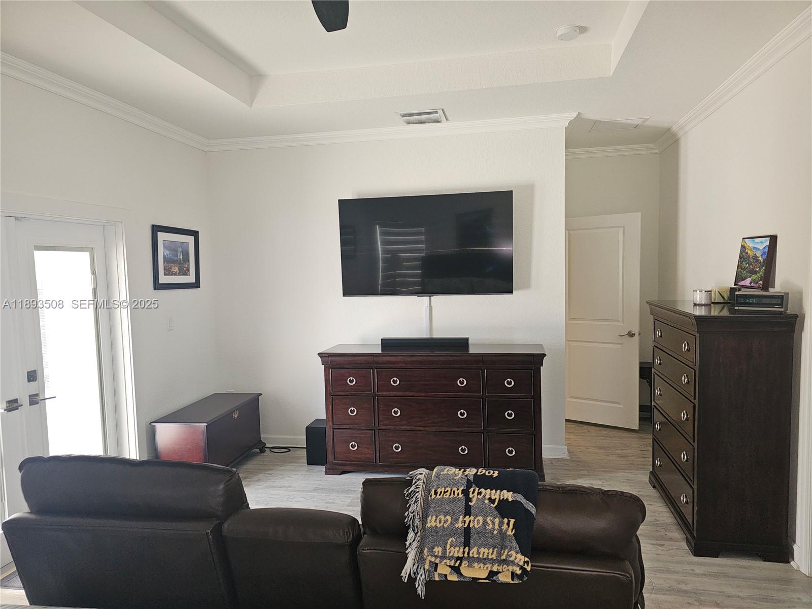 18964 Southwest 135th Avenue Miami, FL 33177 - Photo 21 of 39 a living room with furniture a flat screen tv and a window