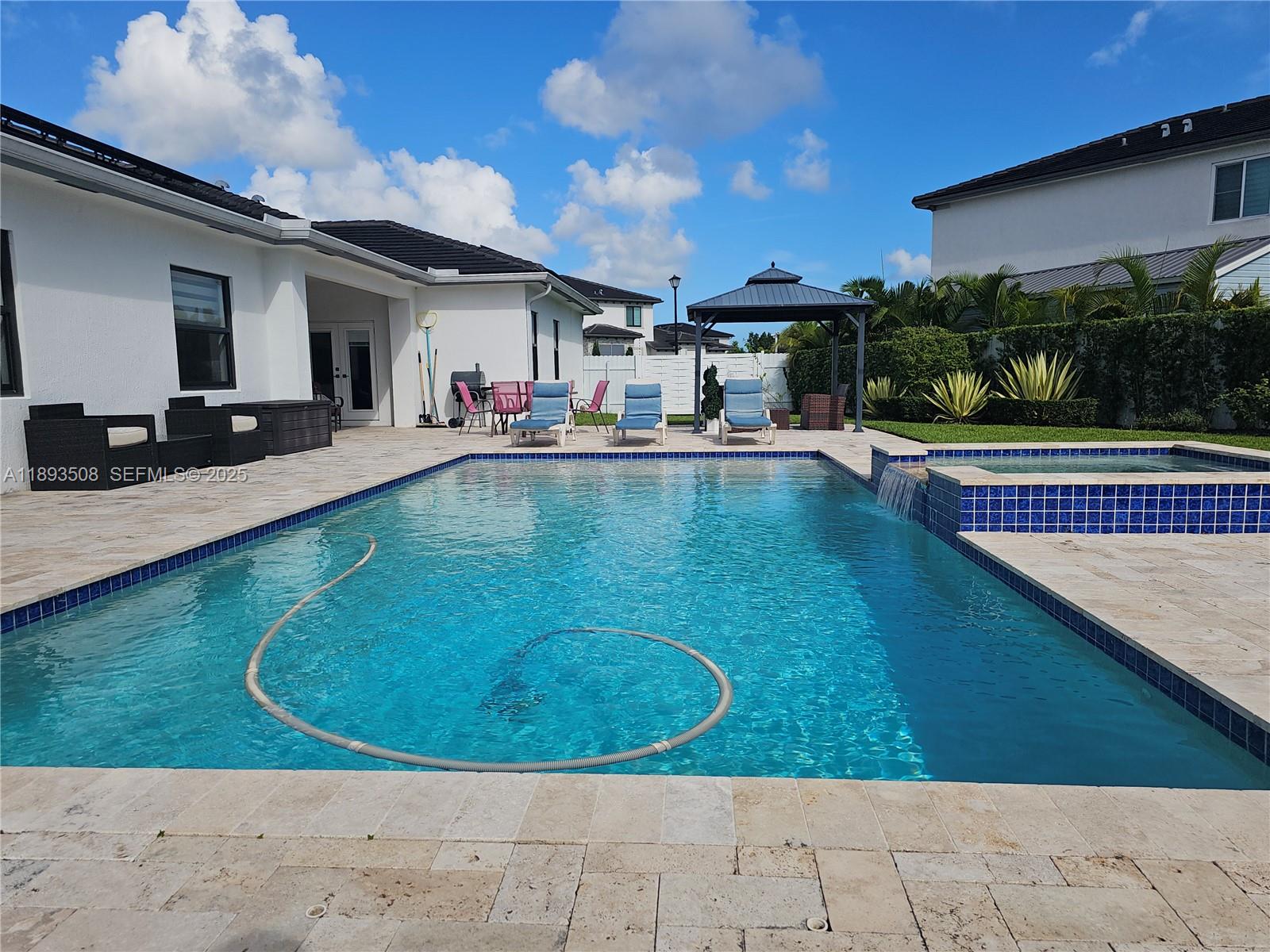 18964 Southwest 135th Avenue Miami, FL 33177 - Photo 25 of 39 a view of a house with swimming pool